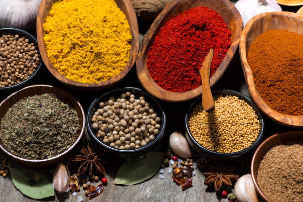 assortment of spices on a wooden background, top view closeup - Photo, Image