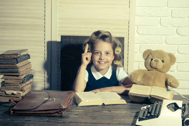 Child with briefcase and typewriter on table. - 写真・画像