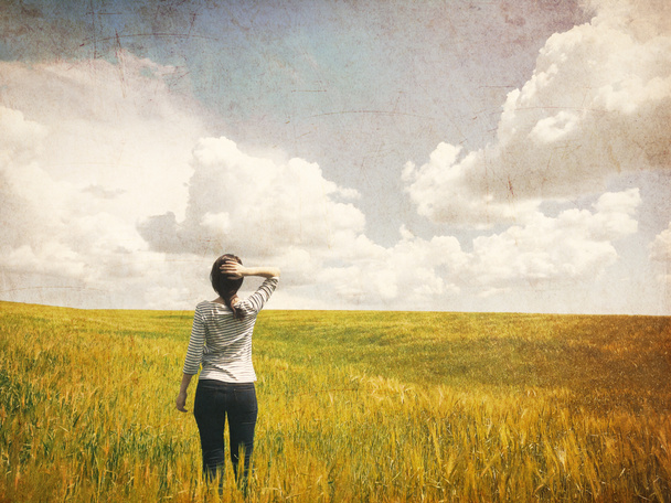 Young woman standing in field - Photo, Image