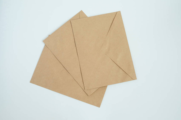 several envelopes from brown letter paper, on white background close-up, top view - Foto, Imagen