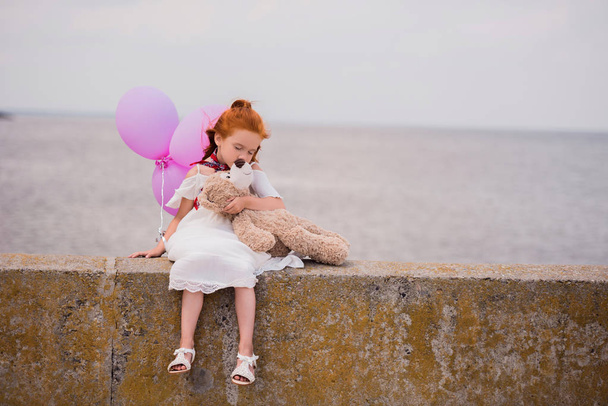 child with teddy bear and balloons - Фото, зображення