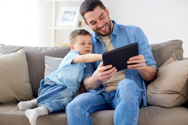 father and son with tablet pc playing at home - Φωτογραφία, εικόνα