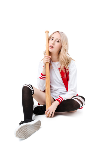 Woman sitting and holding baseball bat - Zdjęcie, obraz