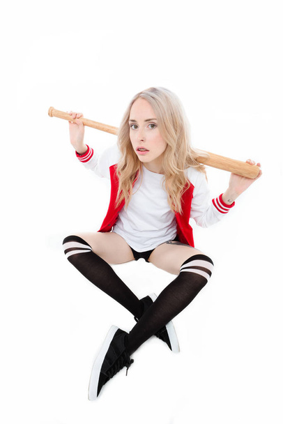Woman sitting and holding baseball bat - Fotografie, Obrázek