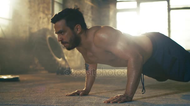 Muscular Shirtless Man Puts Heavy Effort into Doing Push-ups in a Deserted Factory Remodeled into Gym. Part of His Cross Fitness Workout/ High-Intensity Interval Training. - Video