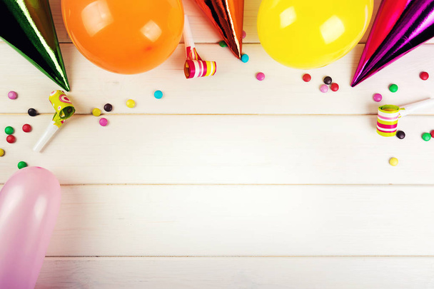 birthday party accessories with copy space on white wood background - Φωτογραφία, εικόνα