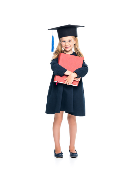 schoolgirl in graduation hat with big book - 写真・画像