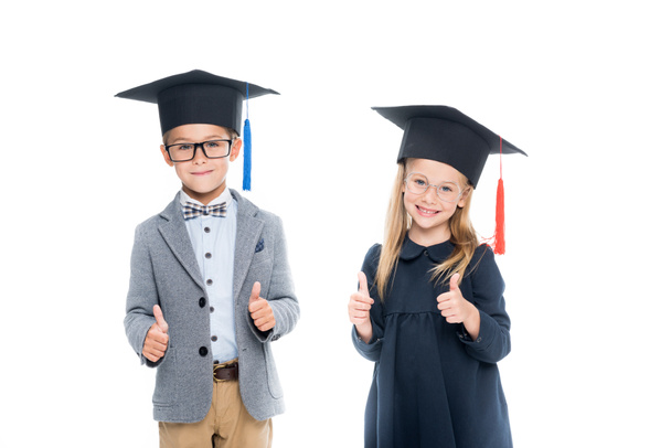 pupils in graduation hats showing thumbs up - Fotografie, Obrázek