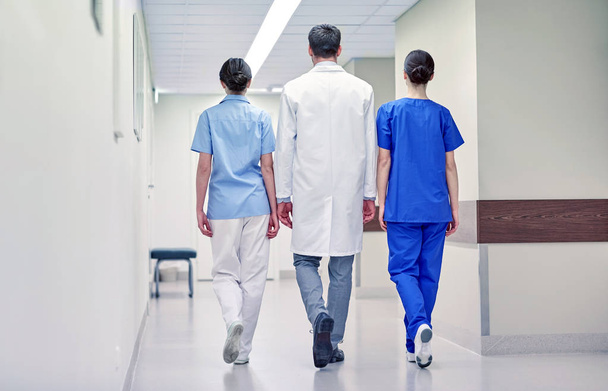 group of medics or doctors walking along hospital - 写真・画像