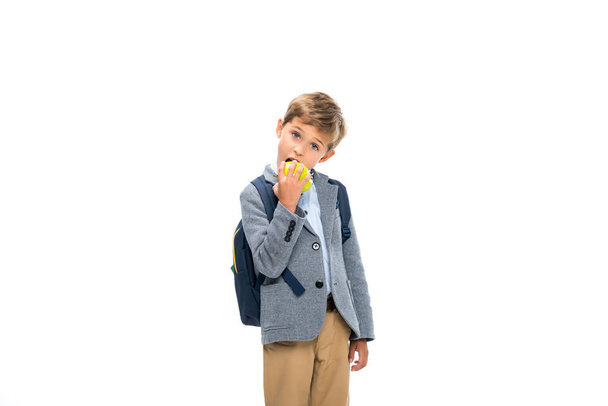 hungry schoolboy eating apple - Fotó, kép