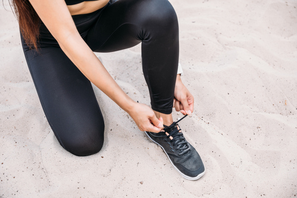 sportswoman tying shoelaces  - Φωτογραφία, εικόνα
