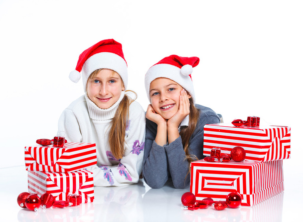 Happy girls in Santa's hat with gift box - Fotó, kép