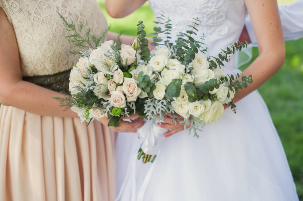 Bride and bridesmaid with bouquets - Φωτογραφία, εικόνα