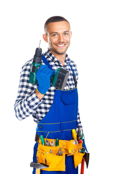 Happy smiling construction worker with drill  - Fotó, kép