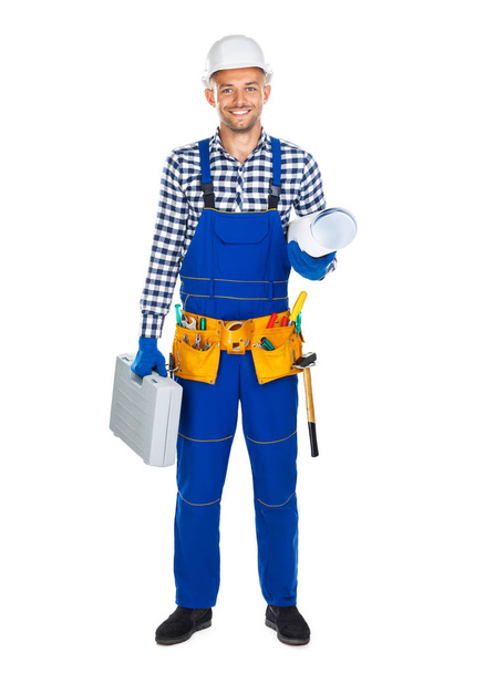 happy construction worker in uniform with toolbox - Foto, afbeelding