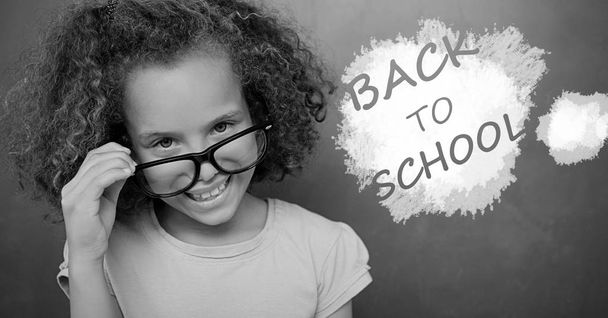 back to school text on blackboard with girl - Фото, изображение