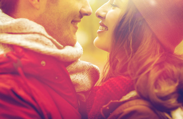 close up of happy young couple kissing outdoors - Photo, Image