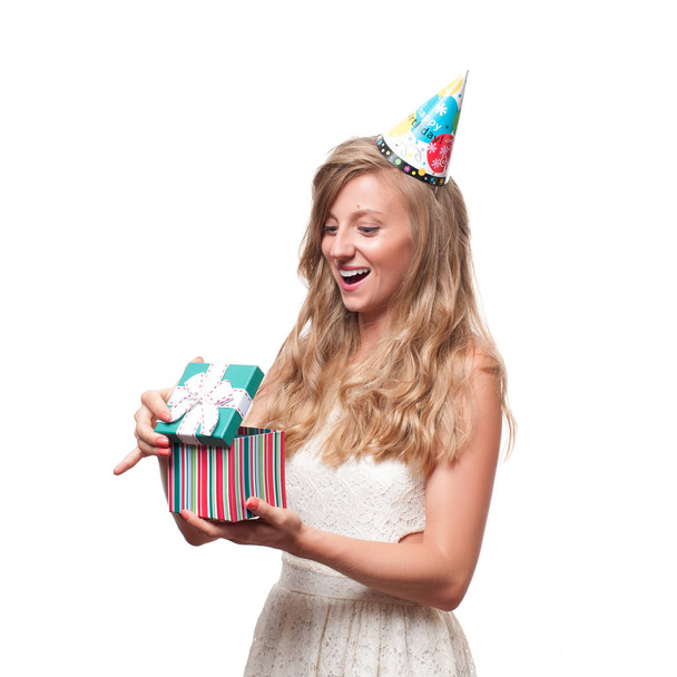 Beautiful happy girl with gift box at celebration birthday party. - Foto, afbeelding