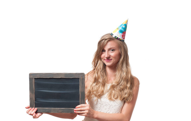 Beautiful happy girl with chalk board at celebration birthday party. - Photo, Image