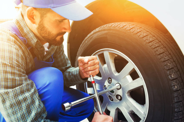 mechanic changing car tire - Fotó, kép