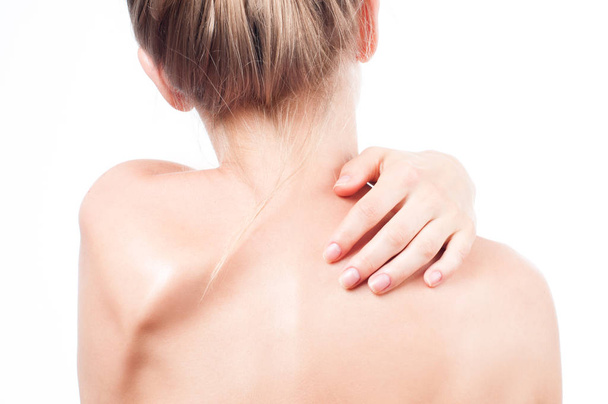 Woman has neck pain. Nude shoulders girl from the back. - Фото, изображение