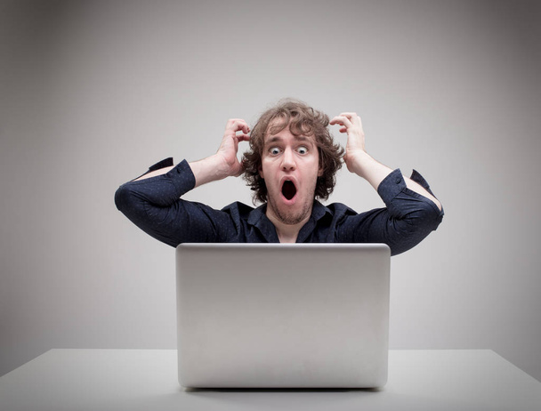 shocked man in front of his computer - Photo, Image
