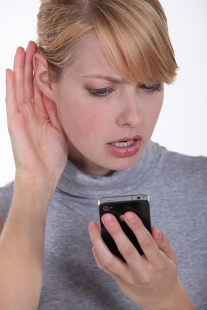 Woman trying to hear a person on the phone - Photo, Image