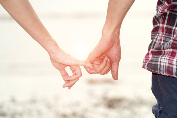 Couple holding hands on the beach - Photo, image