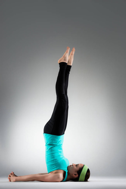 professional yoga women putting shoulder on floor - Fotografie, Obrázek