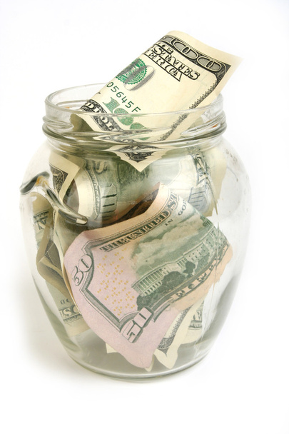 Dollar bills in glass jar - Фото, зображення