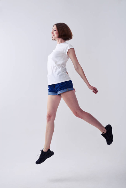 Beautiful female jumping while posing - Fotó, kép