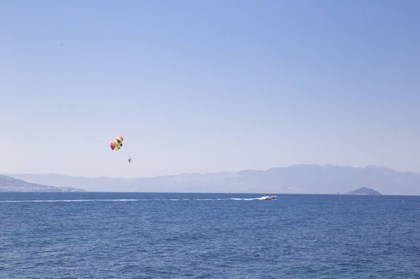 Muž letí na padákem nad mořem, po lodi,  - Fotografie, Obrázek