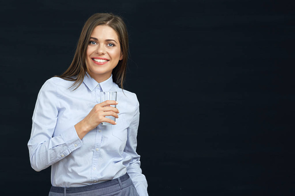 Smiling business woman holding water glass. - 写真・画像