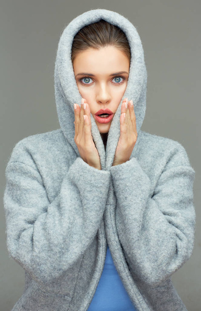 surprising woman wearing coat hood - Foto, imagen
