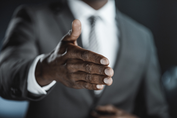 african american businessman with outstretched hand - 写真・画像