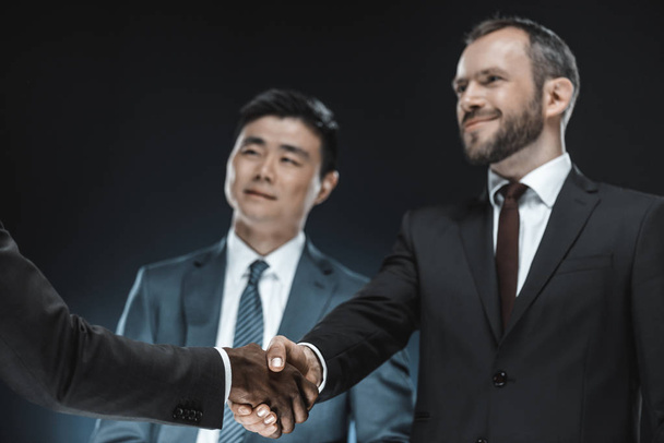multiethnic business partners shaking hands - Foto, Bild