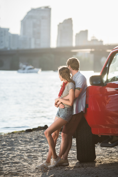 young couple hugging near car - Photo, Image