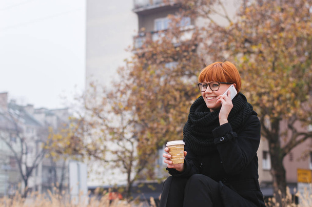 Young redhead woman talking on phone  - Zdjęcie, obraz