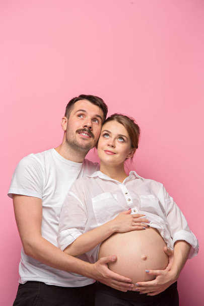 The handsome man and his beautiful pregnant wifes tummy - Valokuva, kuva
