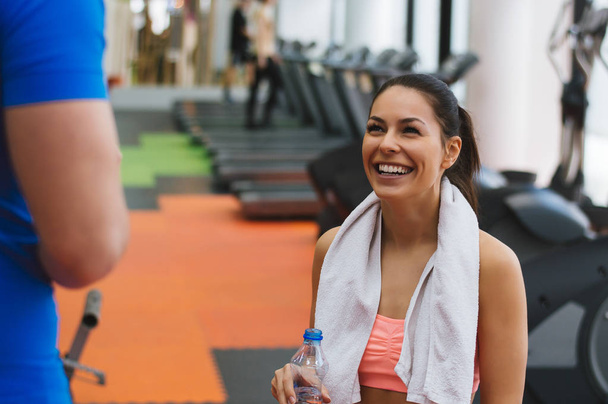 Woman talking to fitness trainer   - 写真・画像