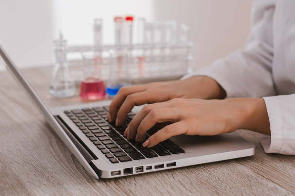 Medical researcher typing on keyboard - Foto, imagen