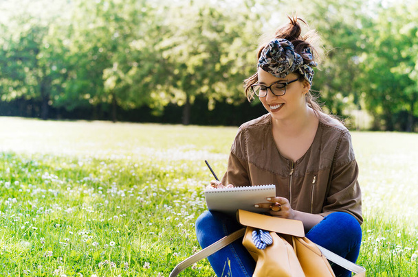 woman studying on grass - Photo, image