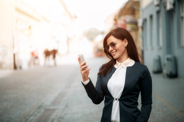 Businesswoman using mobilephone  - Фото, изображение
