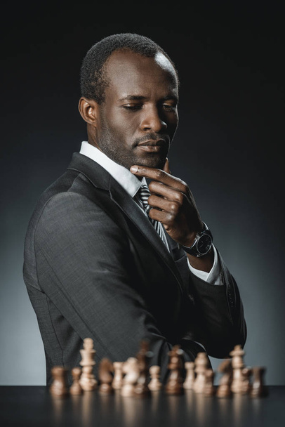 pensive african american businessman and chess - Fotografie, Obrázek