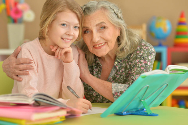 grandmother and granddaughter doing homework - Valokuva, kuva