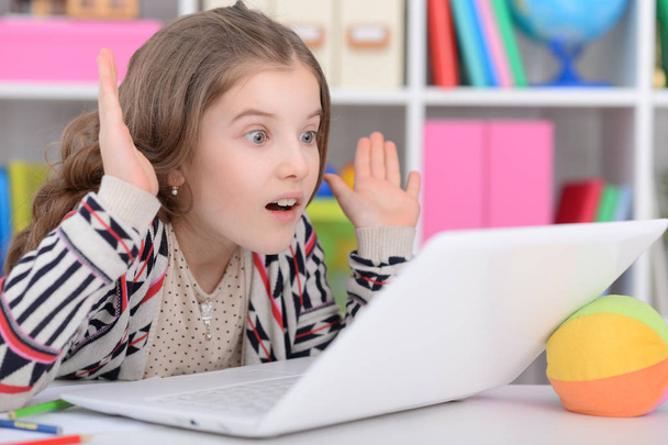 Little girl using modern laptop - Fotó, kép