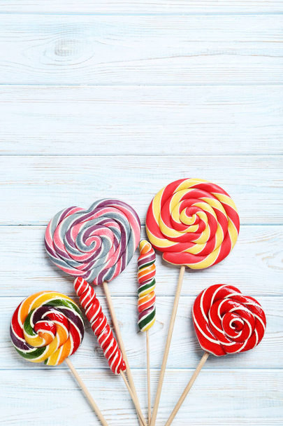 Sweet lollipops on table - Фото, изображение