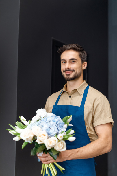 handsome florist with flowers - Zdjęcie, obraz