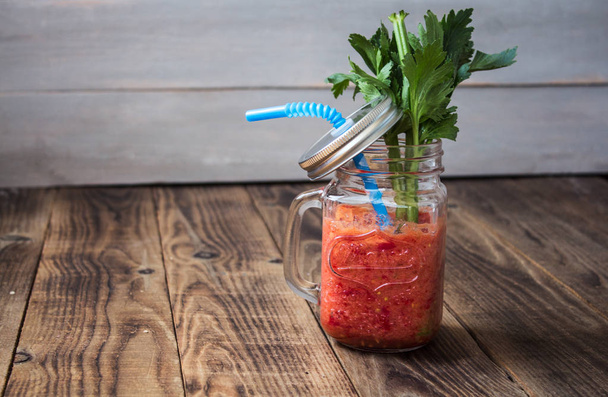 Fresh tomato smoothies and celery in a jar - Fotó, kép