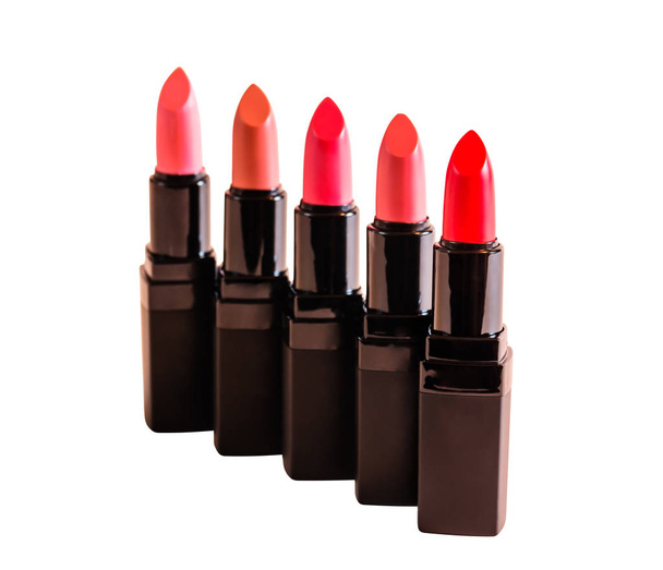 Set of beautiful lipsticks isolated on white background. Selective focus on red lipstick - Photo, Image